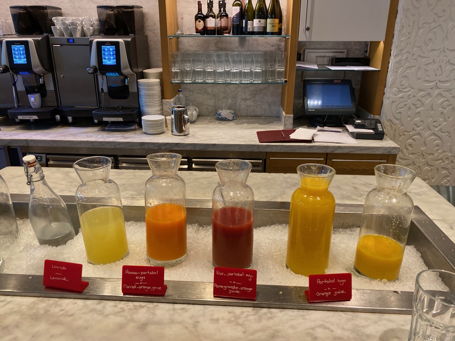 a row of glasses with different colored liquid in them