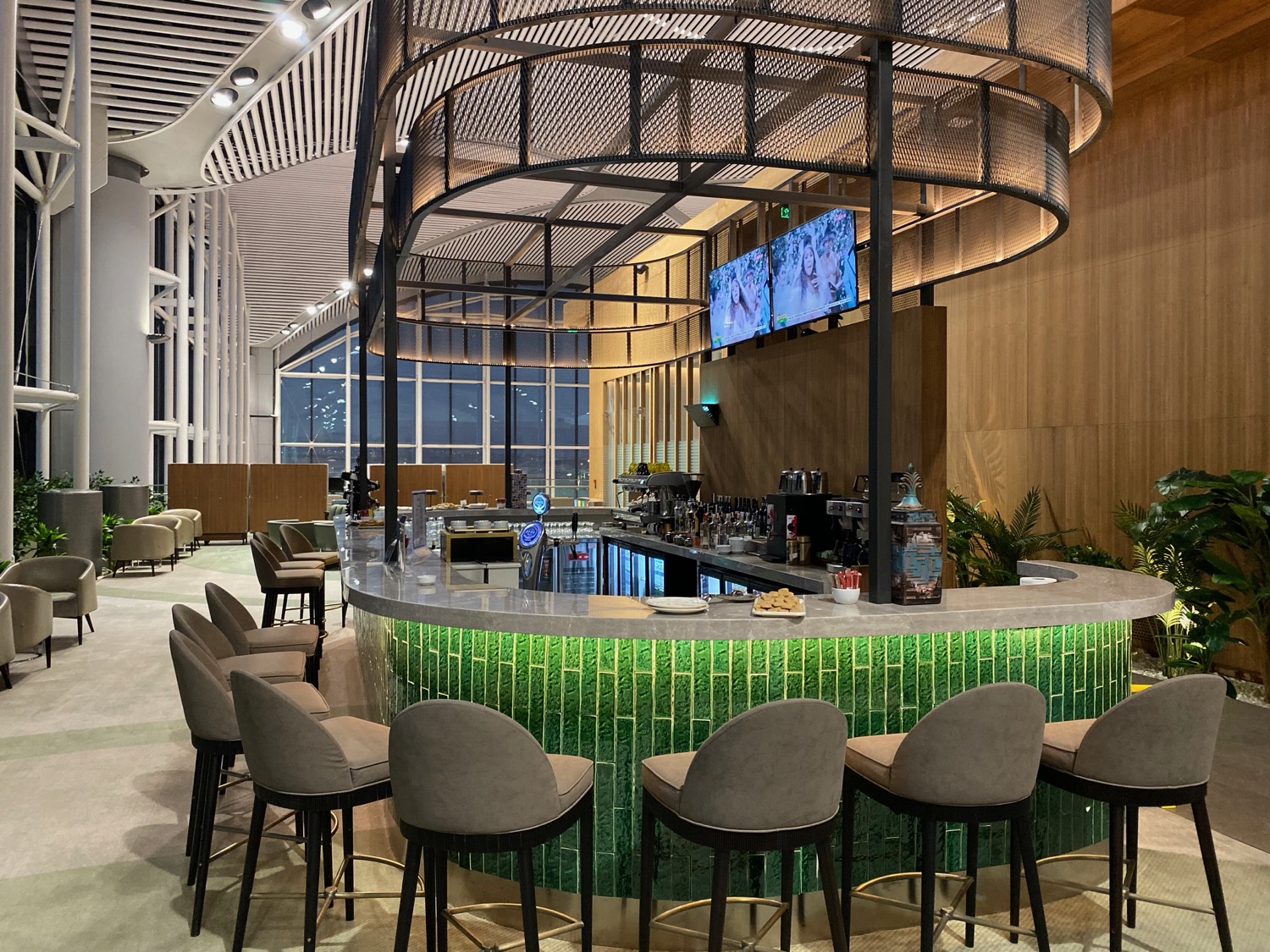 a bar with chairs and a green counter