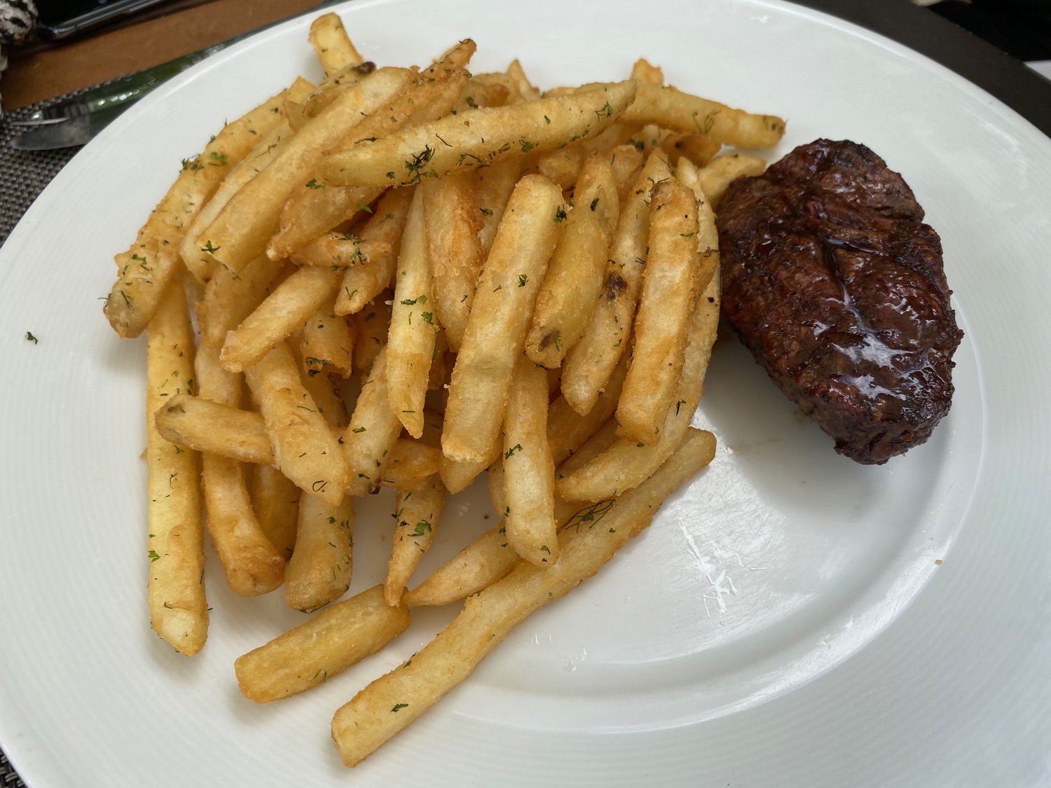 a plate of french fries and steak