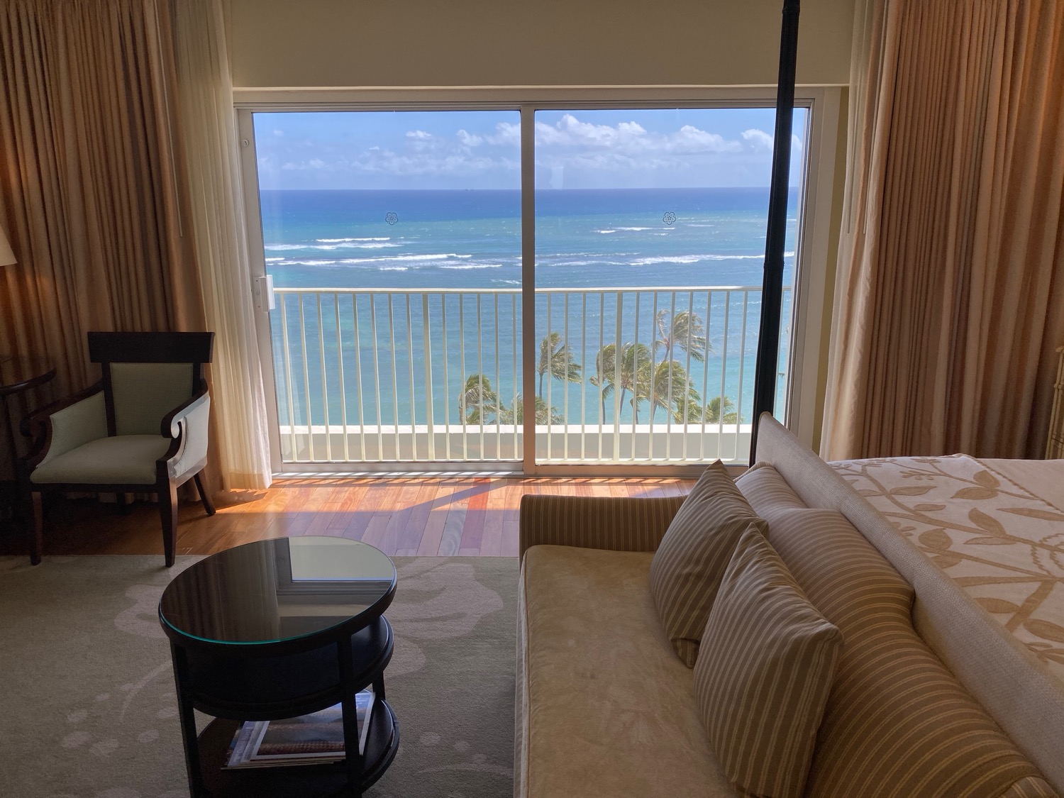 a room with a view of the ocean and a couch
