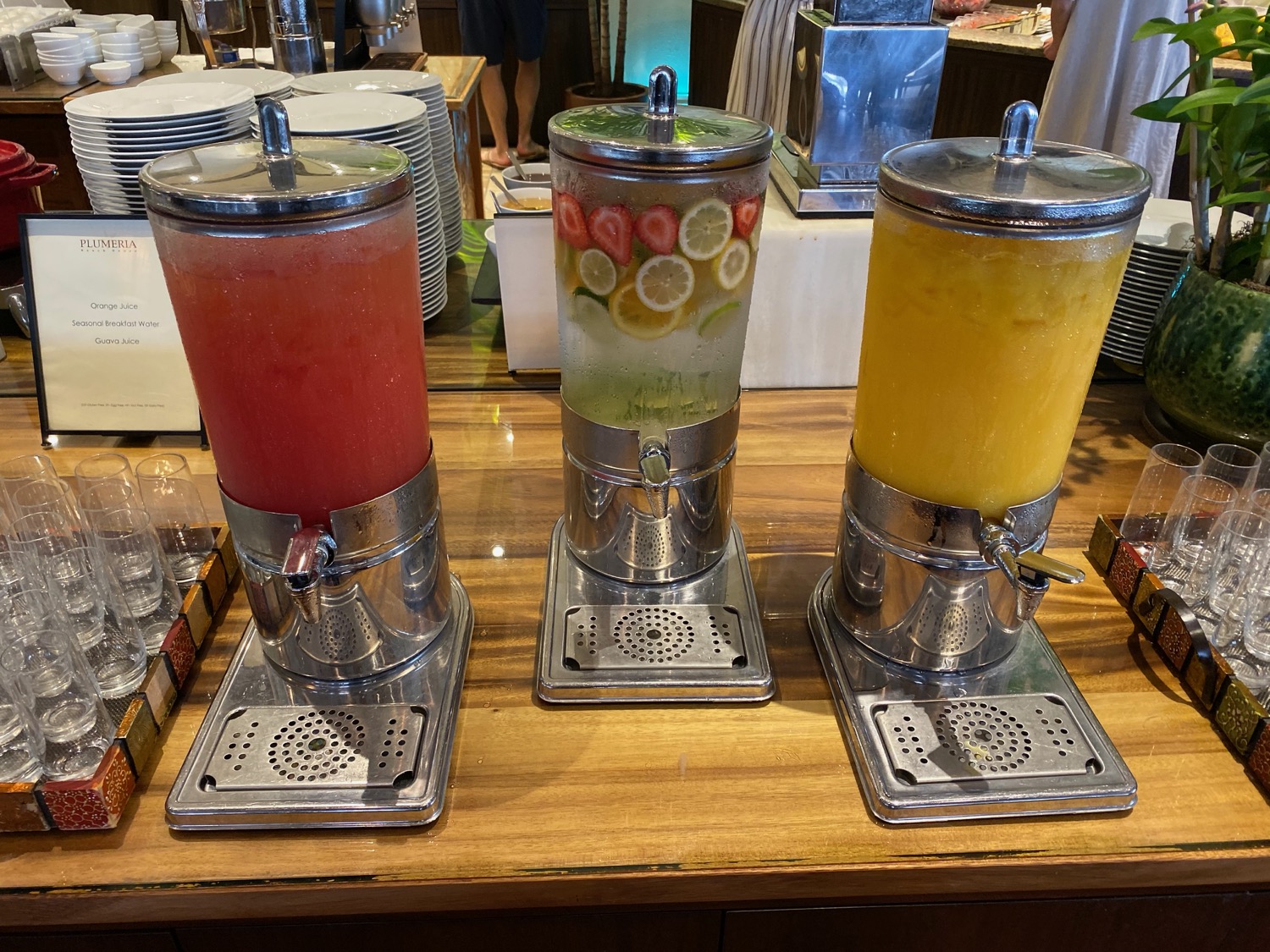 a group of drinks dispensers on a table