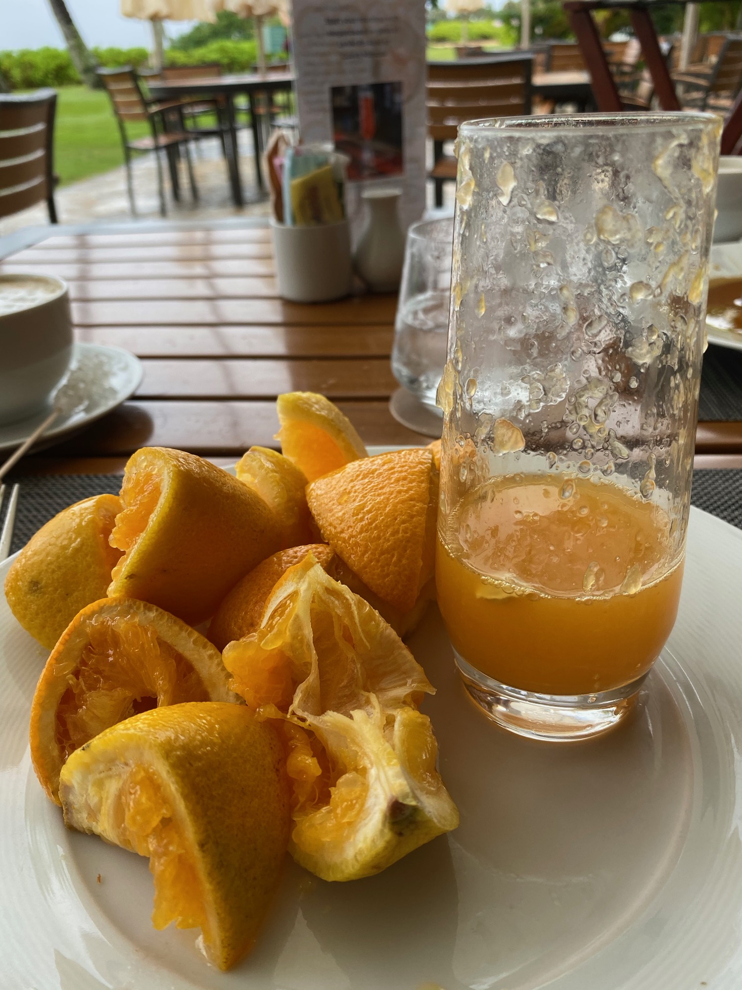 a plate of oranges and a glass of juice