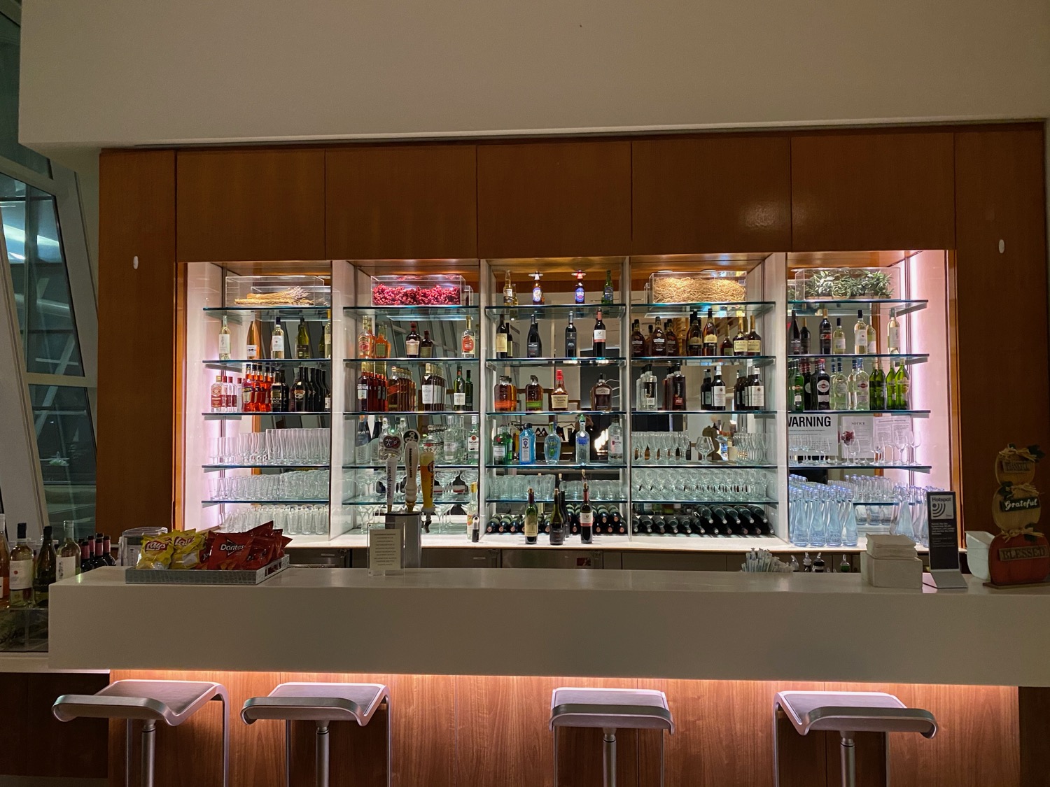 a bar with shelves of liquor and glasses