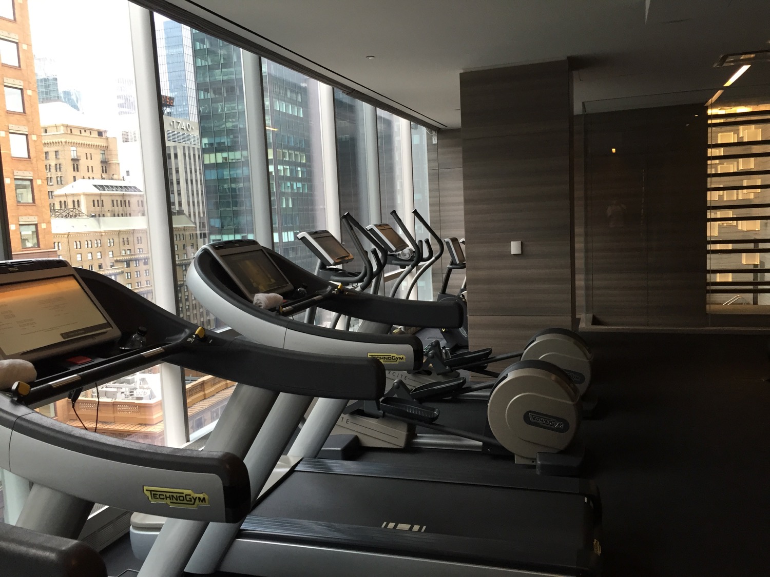 a group of treadmills in a room with a window