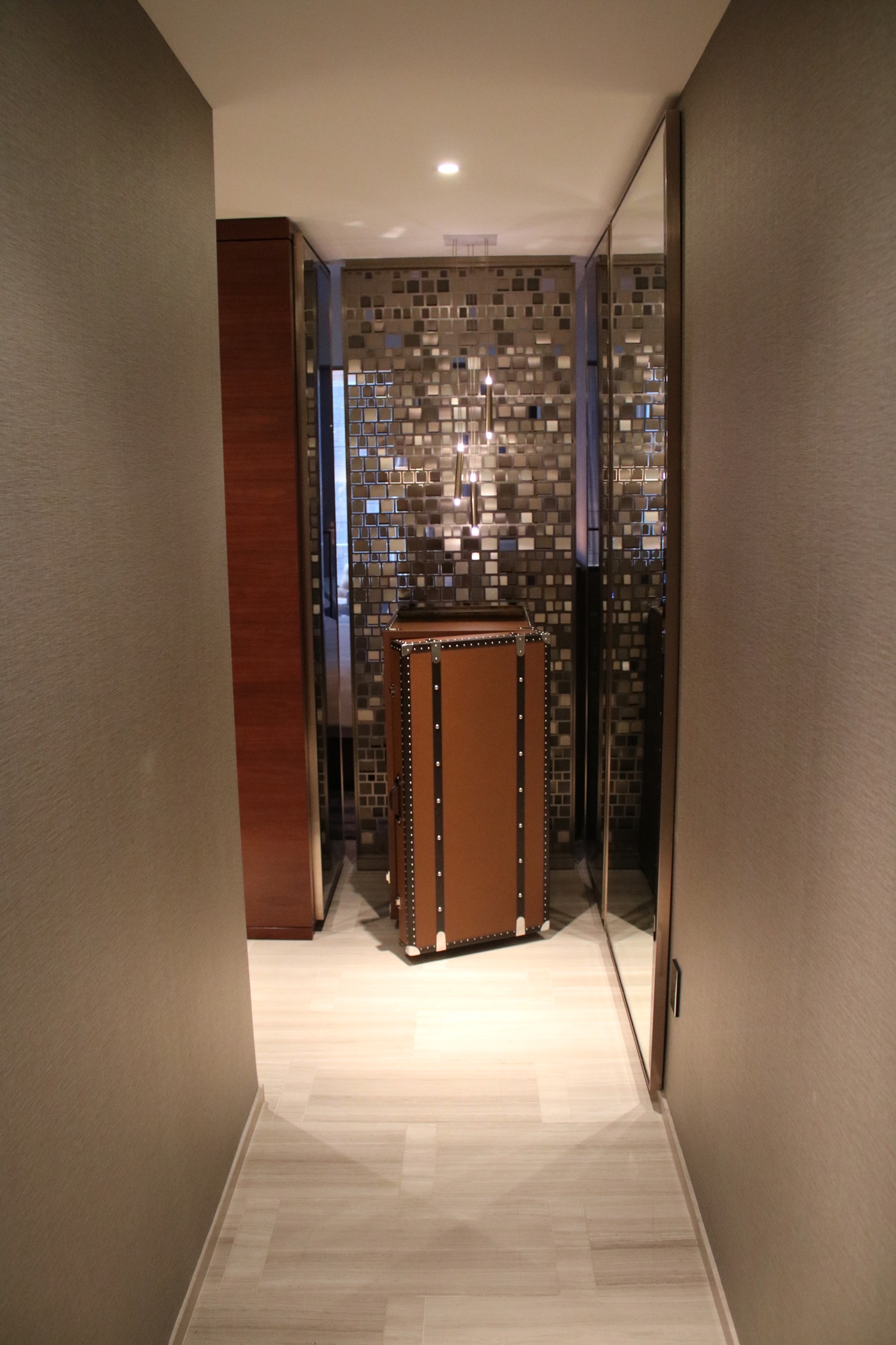 a mirror wall with a brown chest