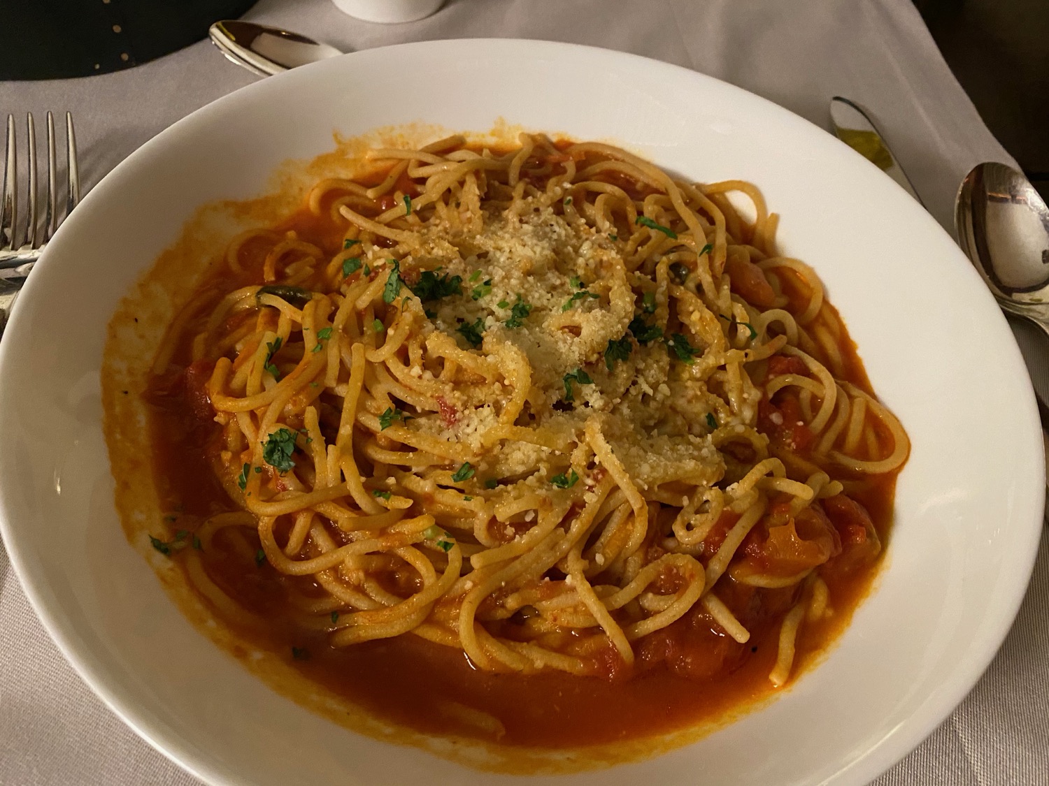 a bowl of spaghetti with sauce and cheese