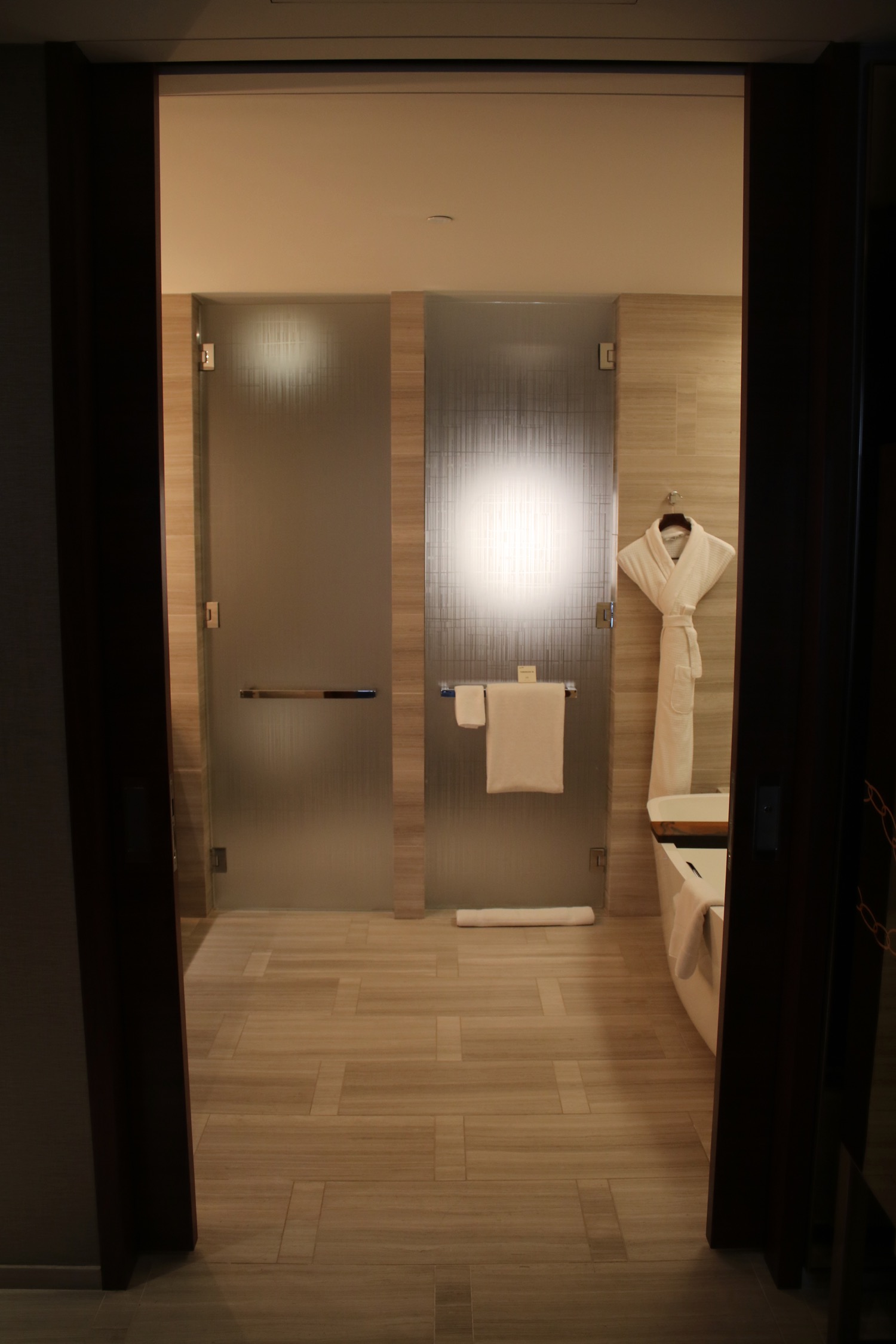 a bathroom with a bathtub and shower doors