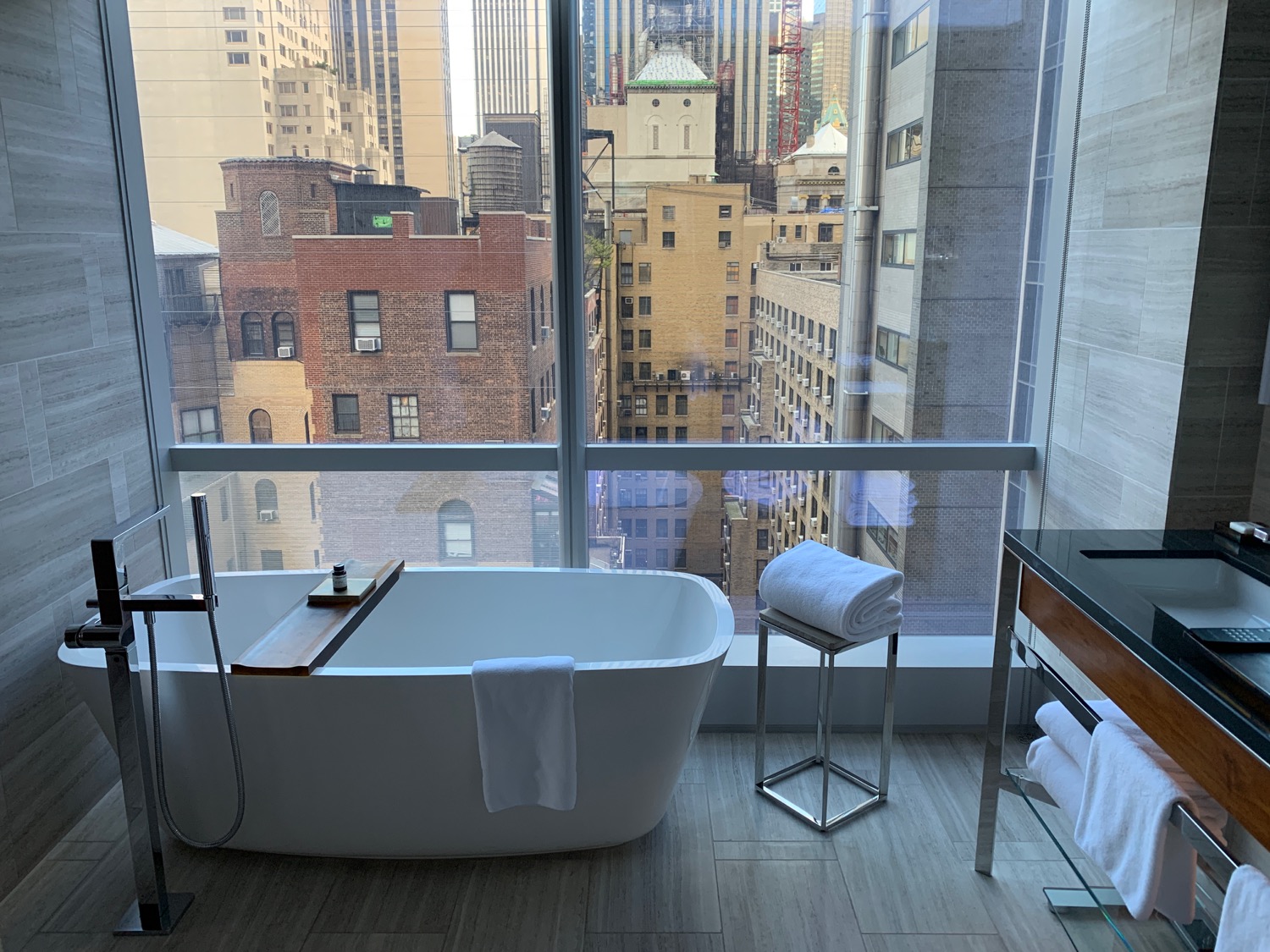 a bathroom with a large window and a tub
