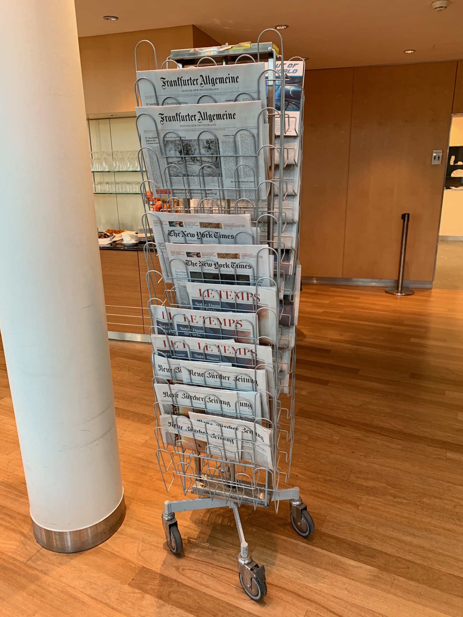 a rack of newspapers on a wood floor