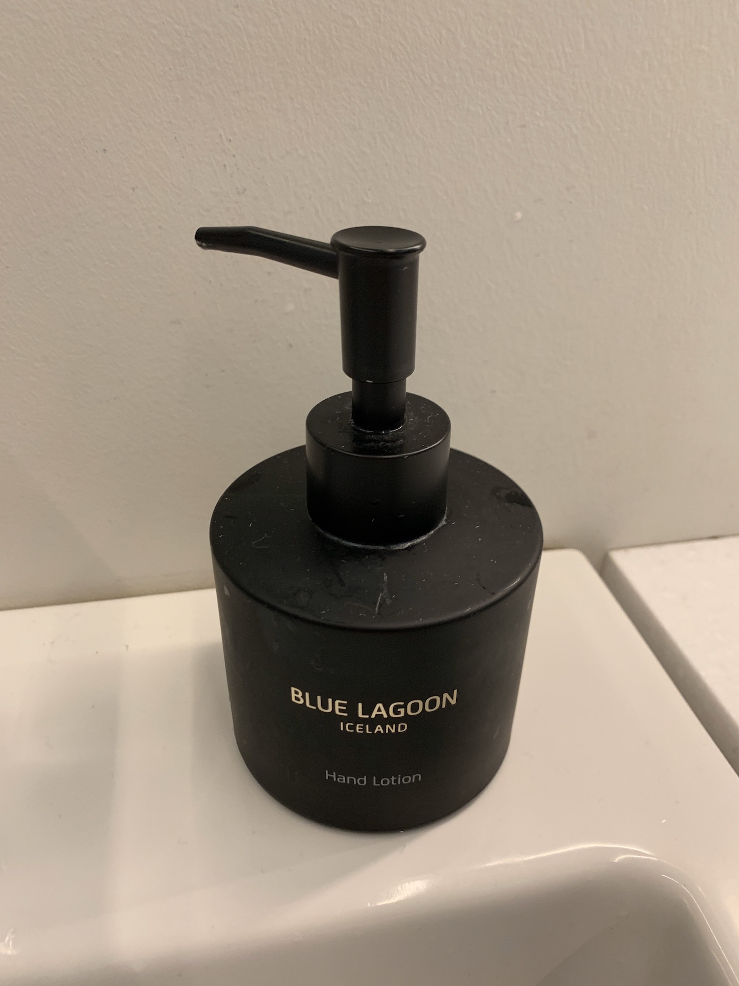 a black bottle with a pump