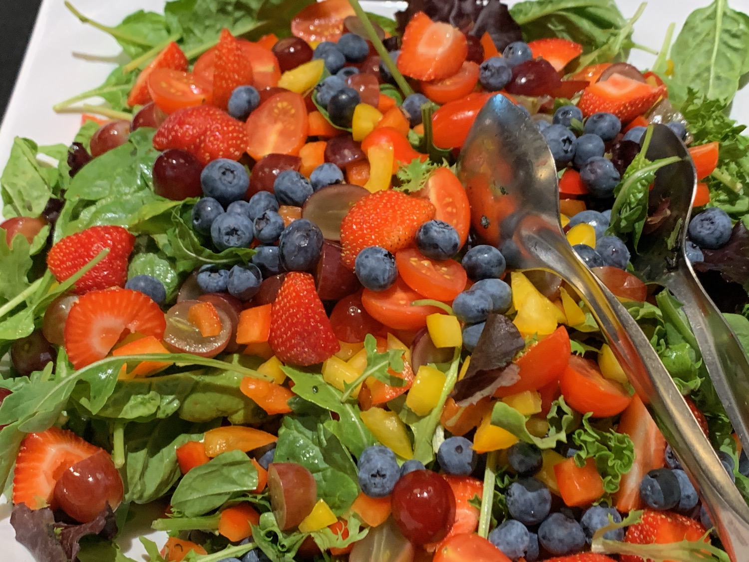 a salad with fruit and vegetables