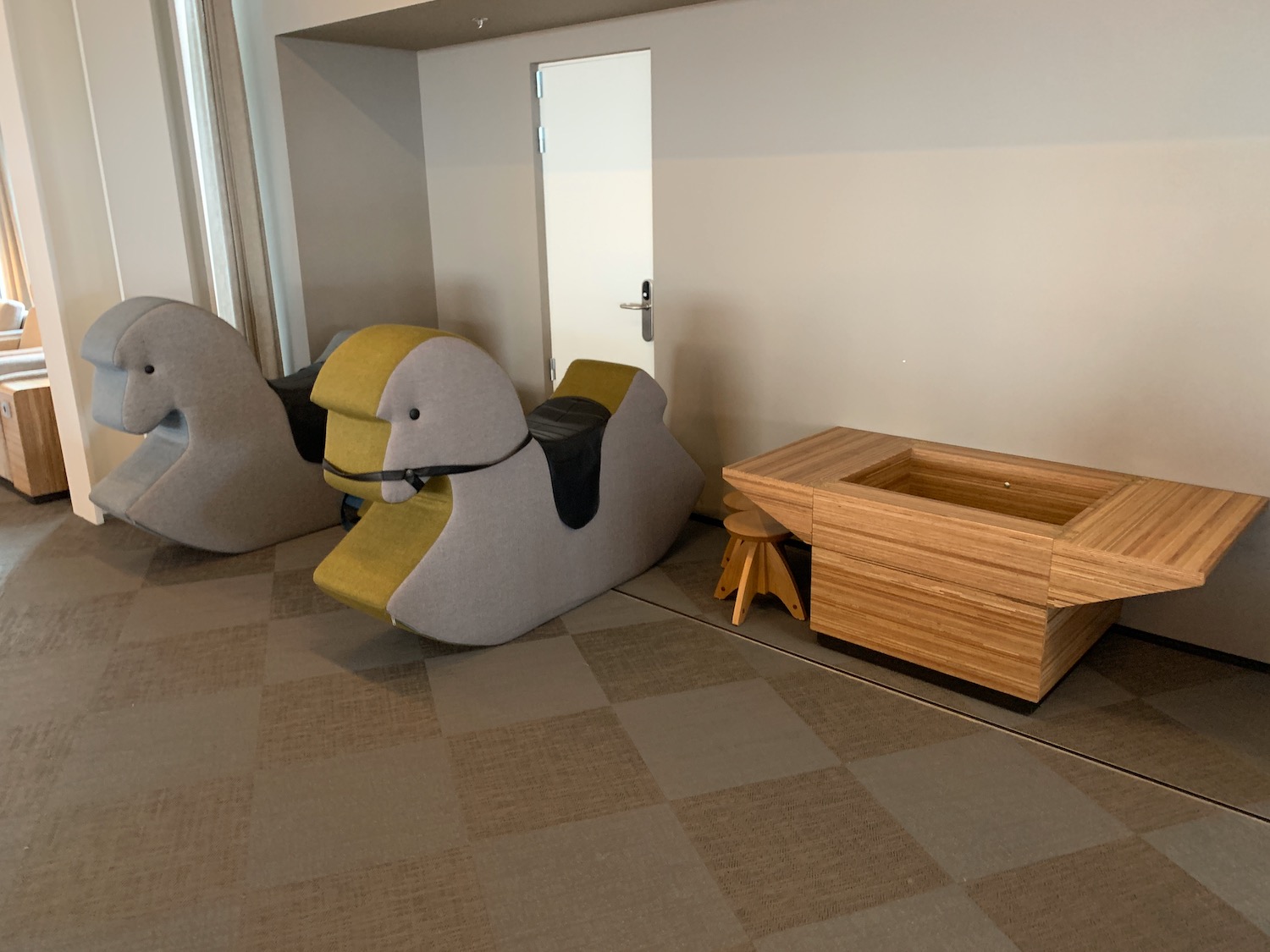 a group of rocking horses in a room