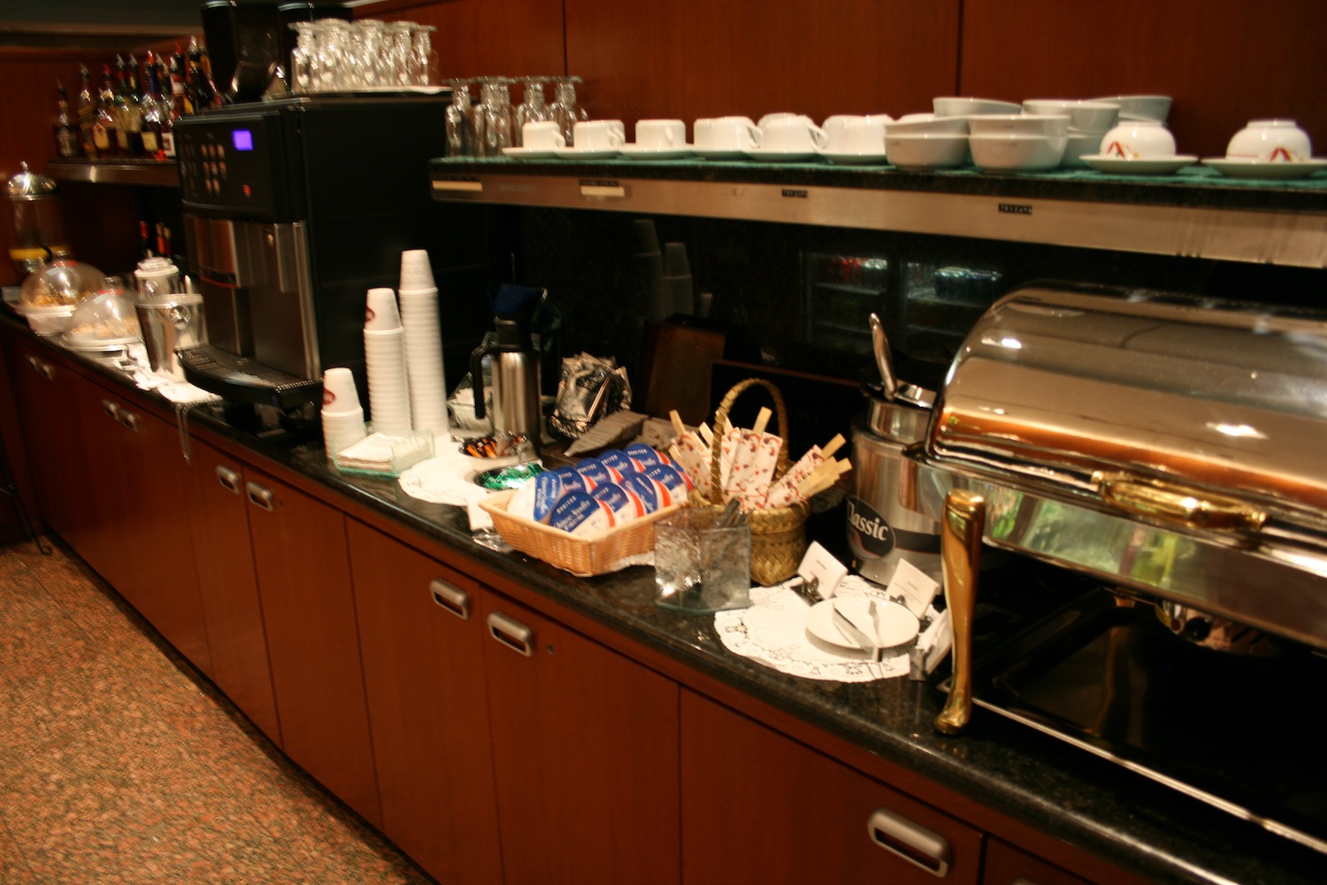 a counter with a coffee machine and cups