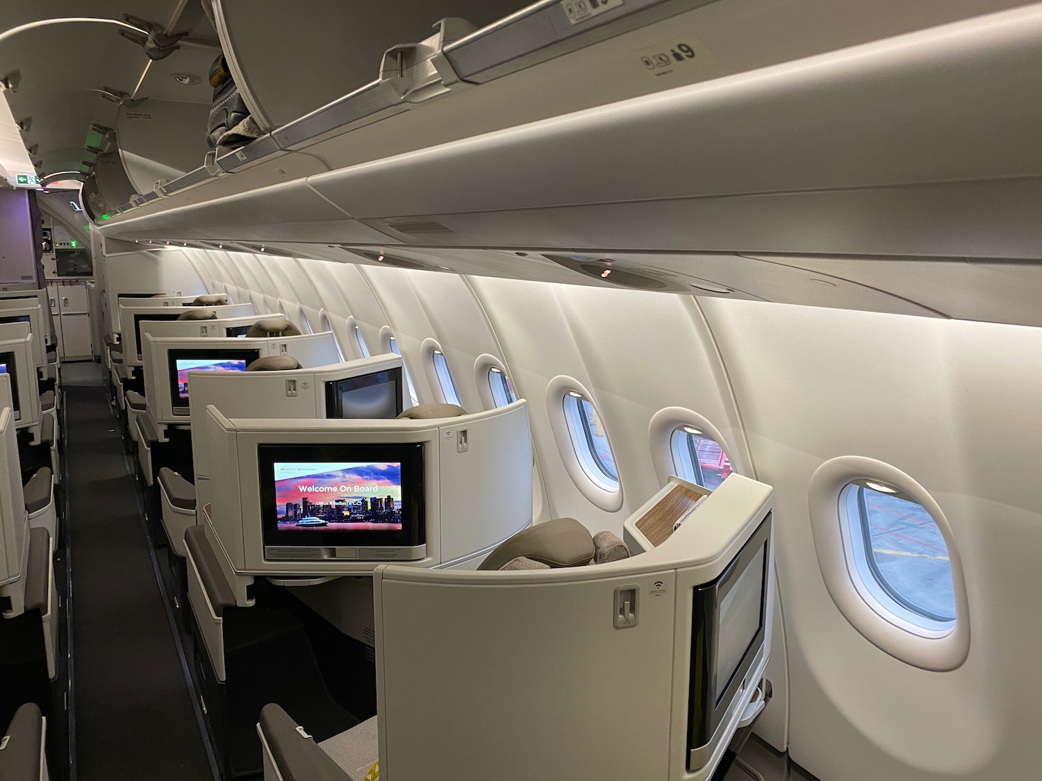 a row of seats with tvs on the side