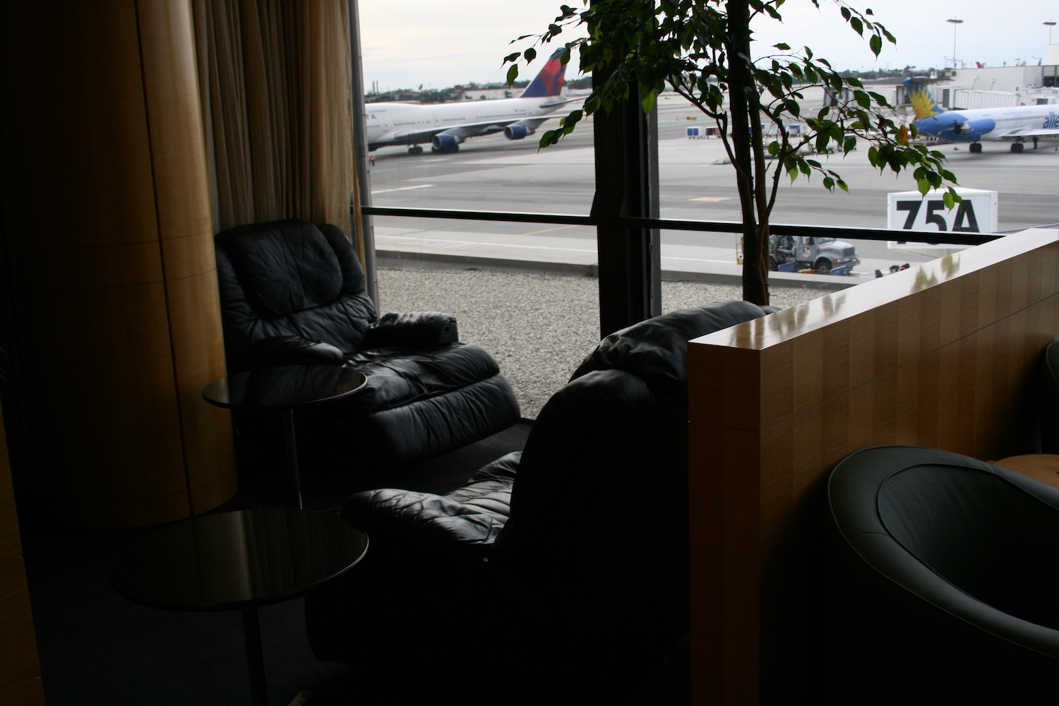a lounge area with a plane in the background