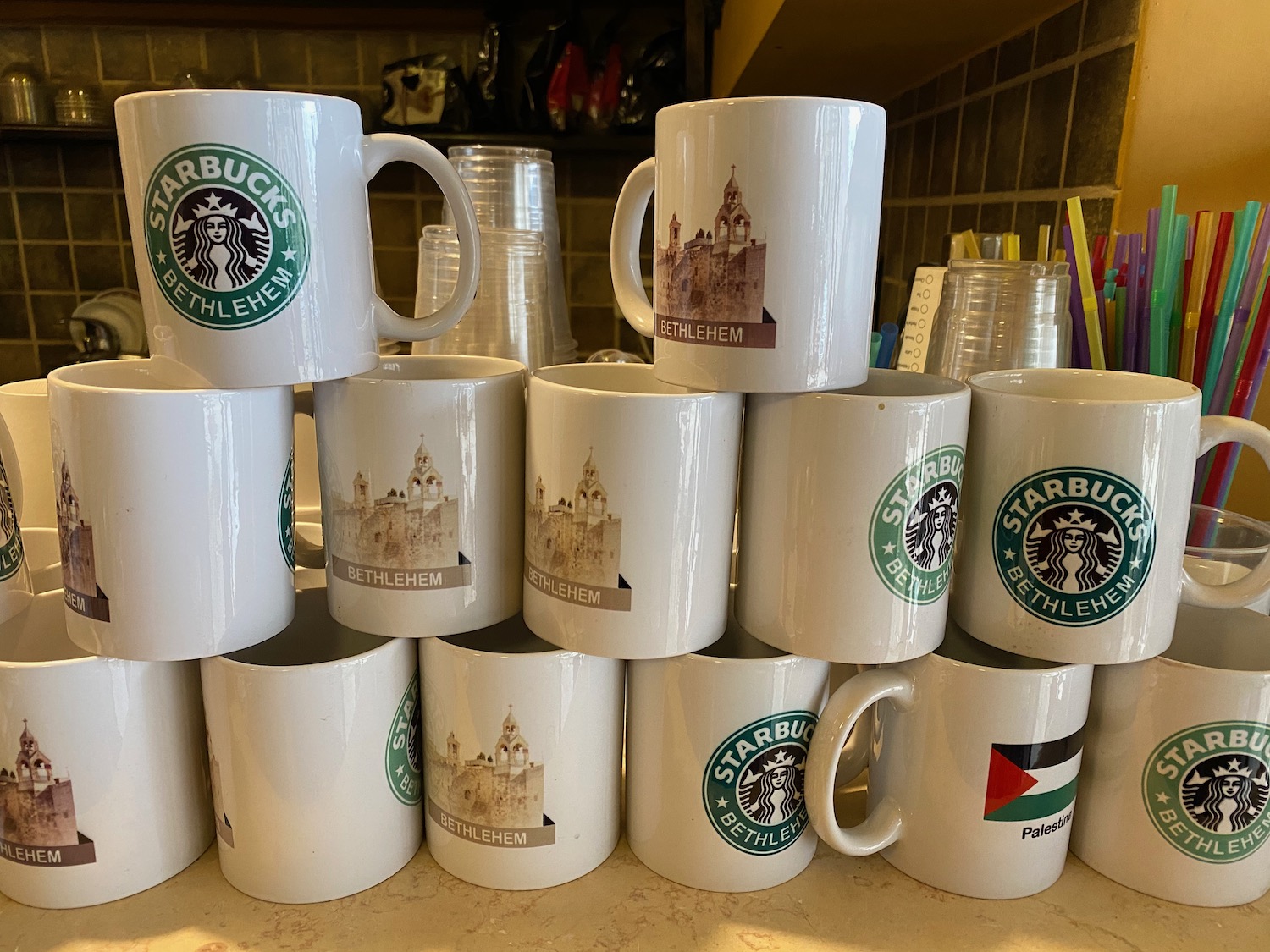 a stack of white mugs with images on them