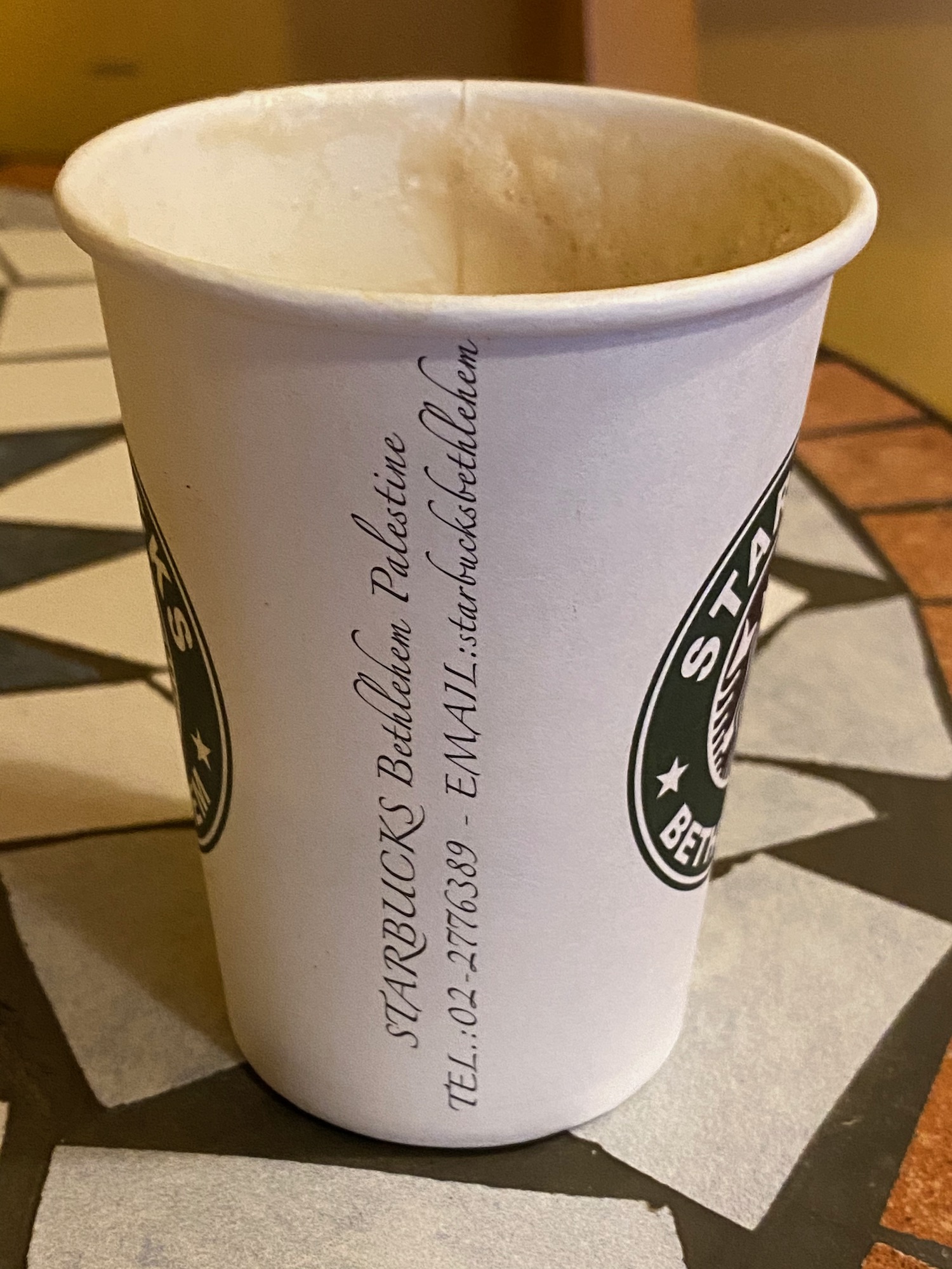 a white cup with black text on it