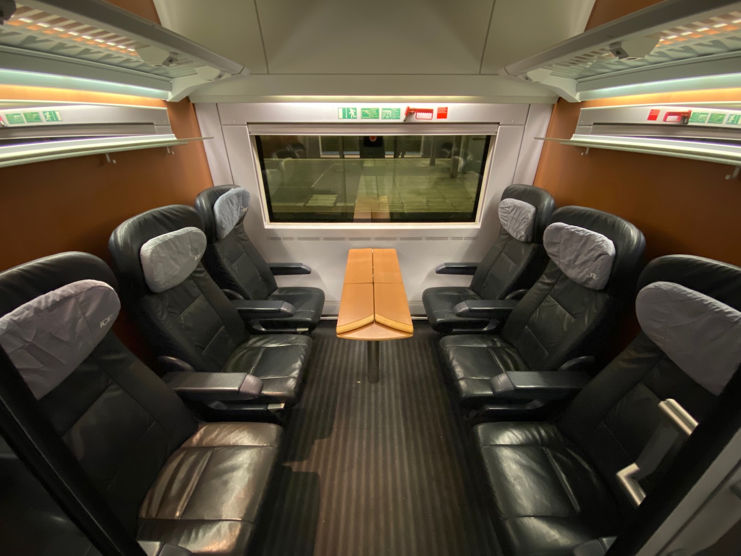 inside a train with seats and a table