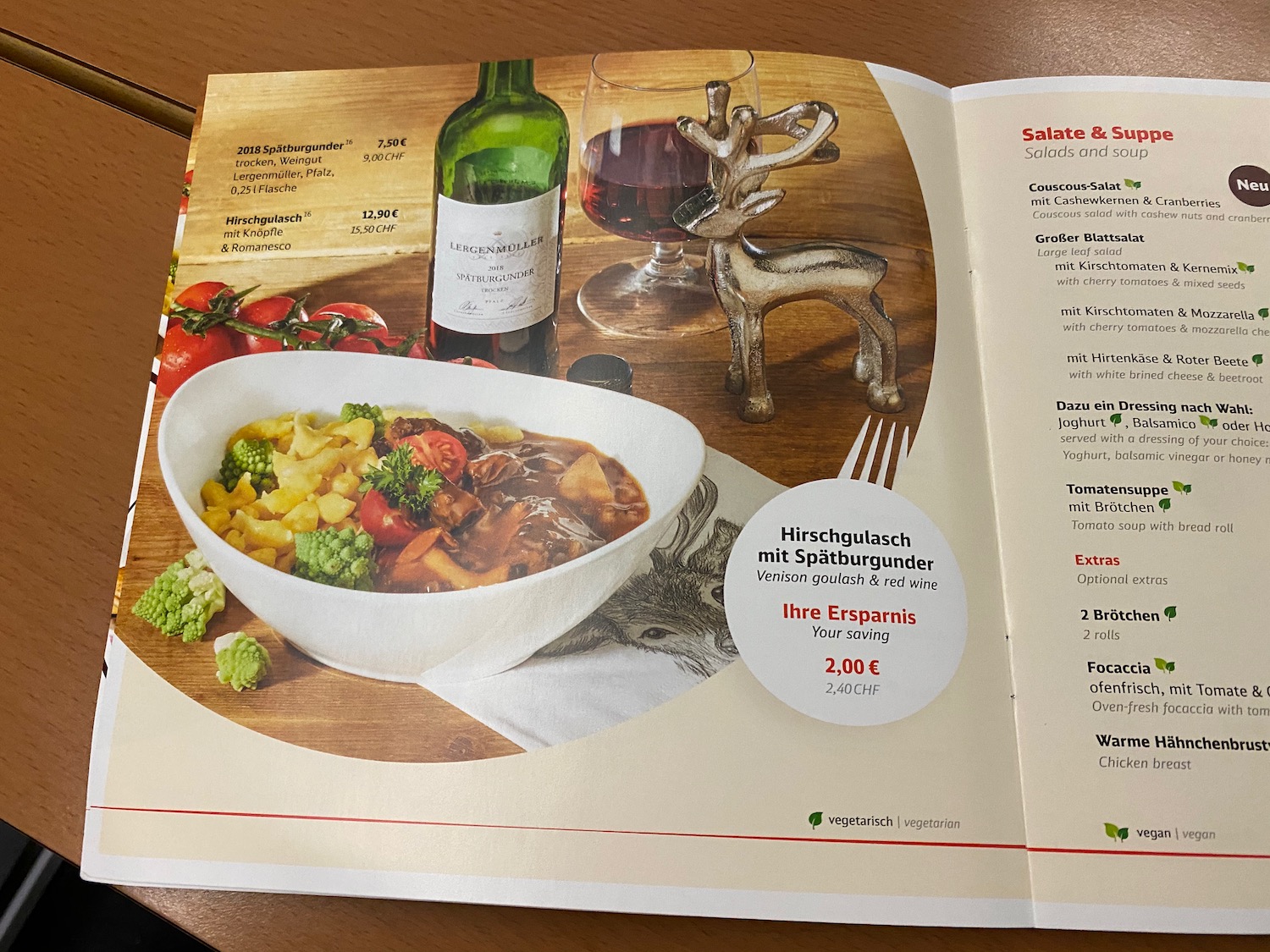 a menu with a picture of food and wine