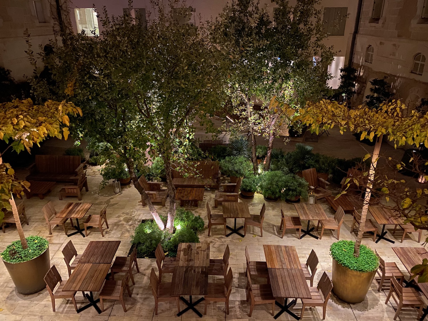 a group of tables and chairs in a courtyard