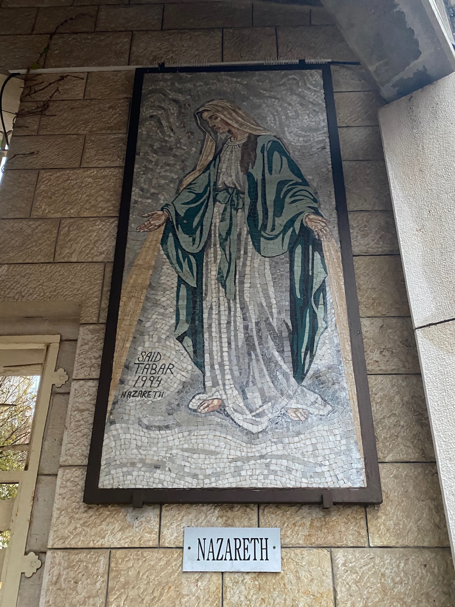 a mosaic of a woman on a wall