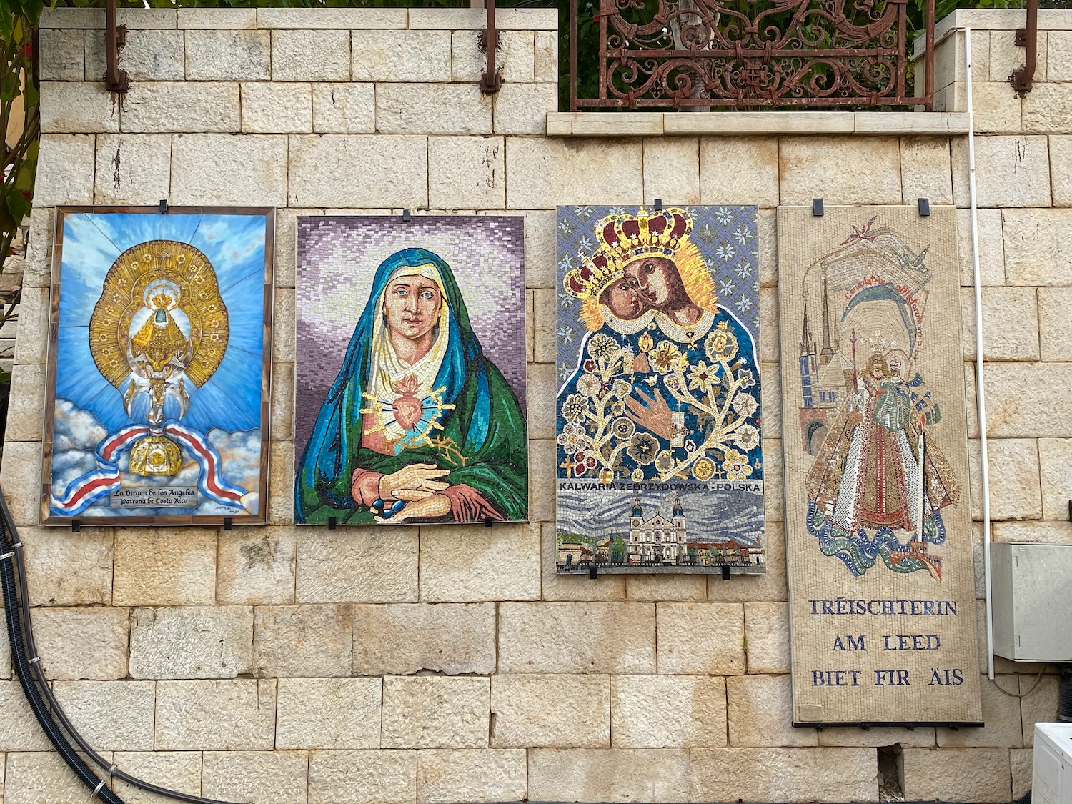 a group of paintings on a stone wall