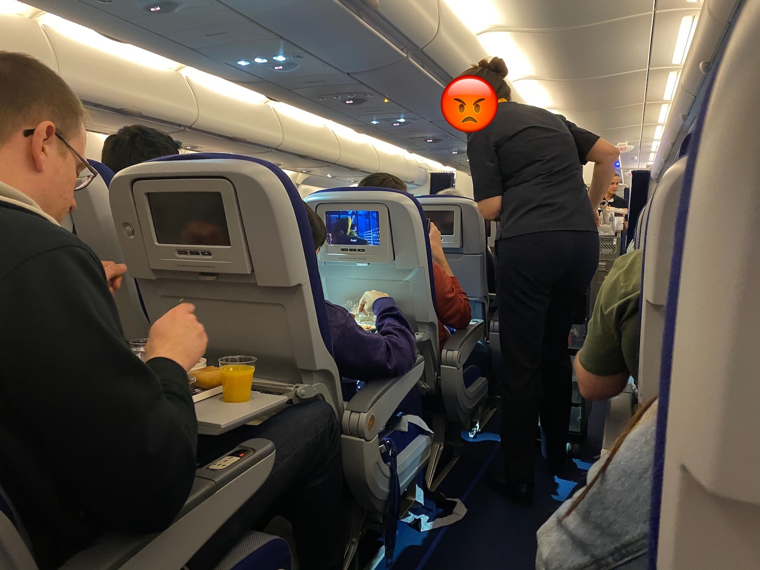 a person standing in a row of seats on an airplane