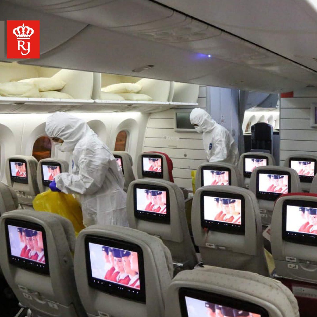 people in hazmat suits in an airplane