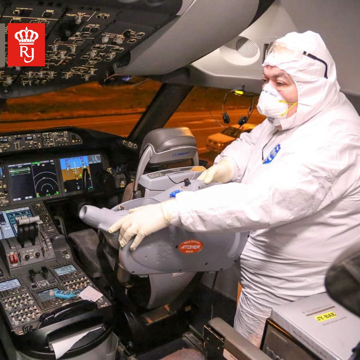 a man in a white suit in a cockpit