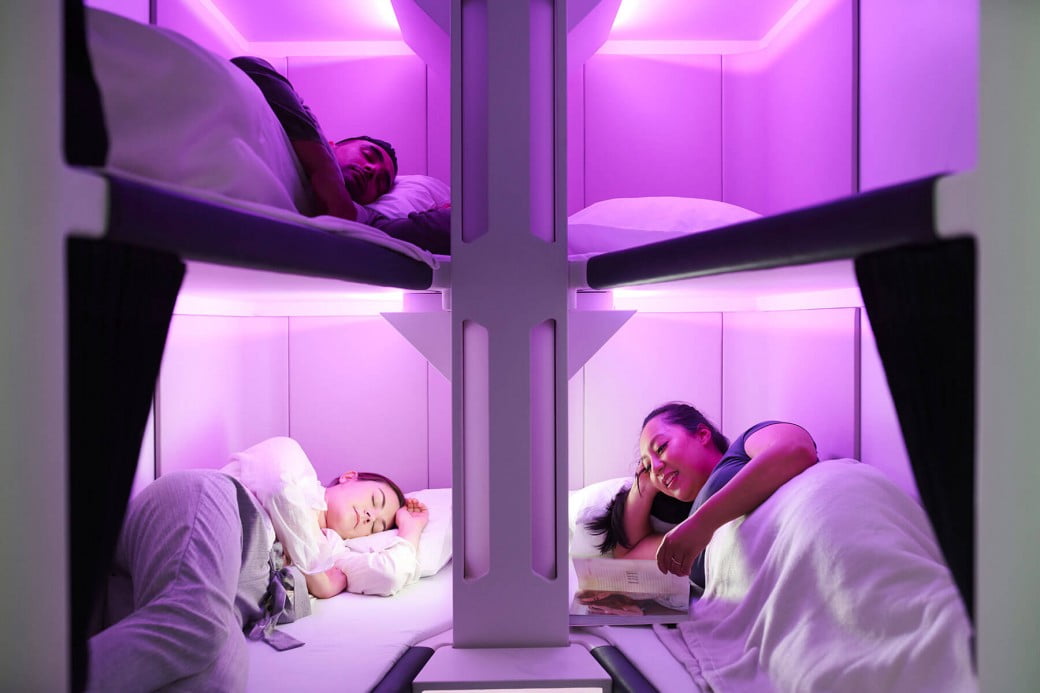 a group of people sleeping in a bunk bed