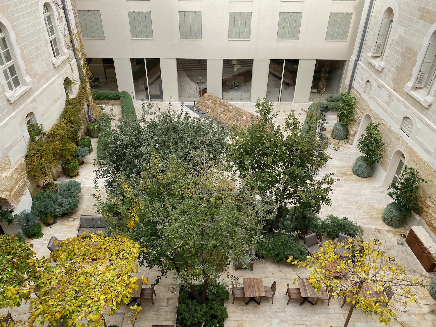 a courtyard with trees and chairs
