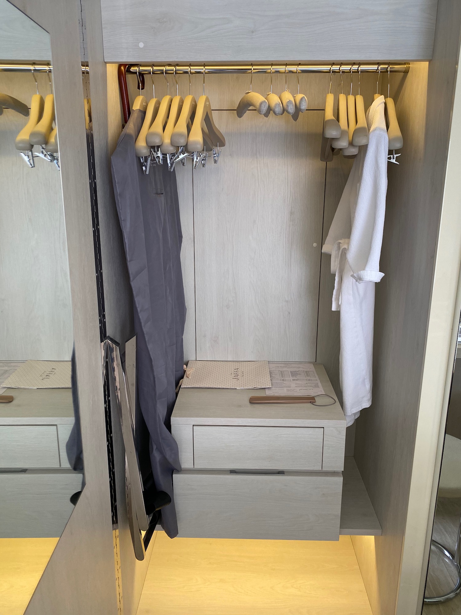 a closet with clothes on swingers