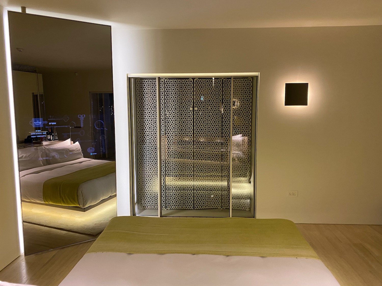 a room with a bed and a glass door