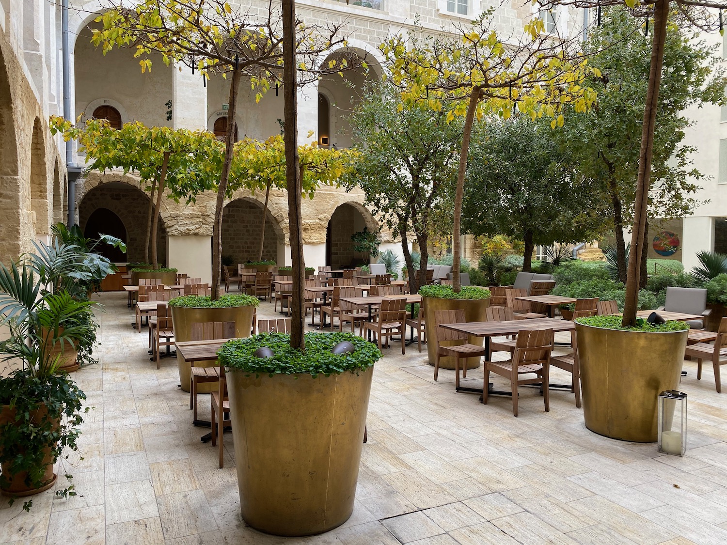 a courtyard with tables and chairs and trees