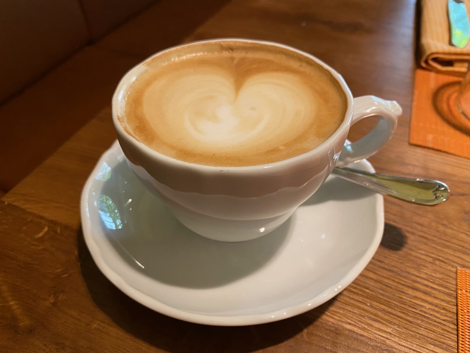 a cup of coffee with a heart design on top