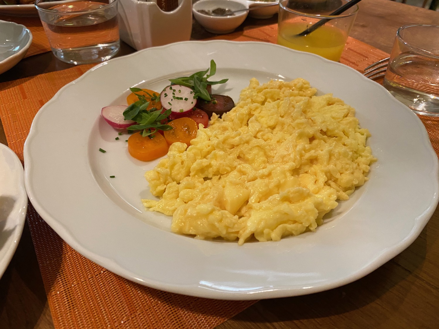 a plate of scrambled eggs and vegetables