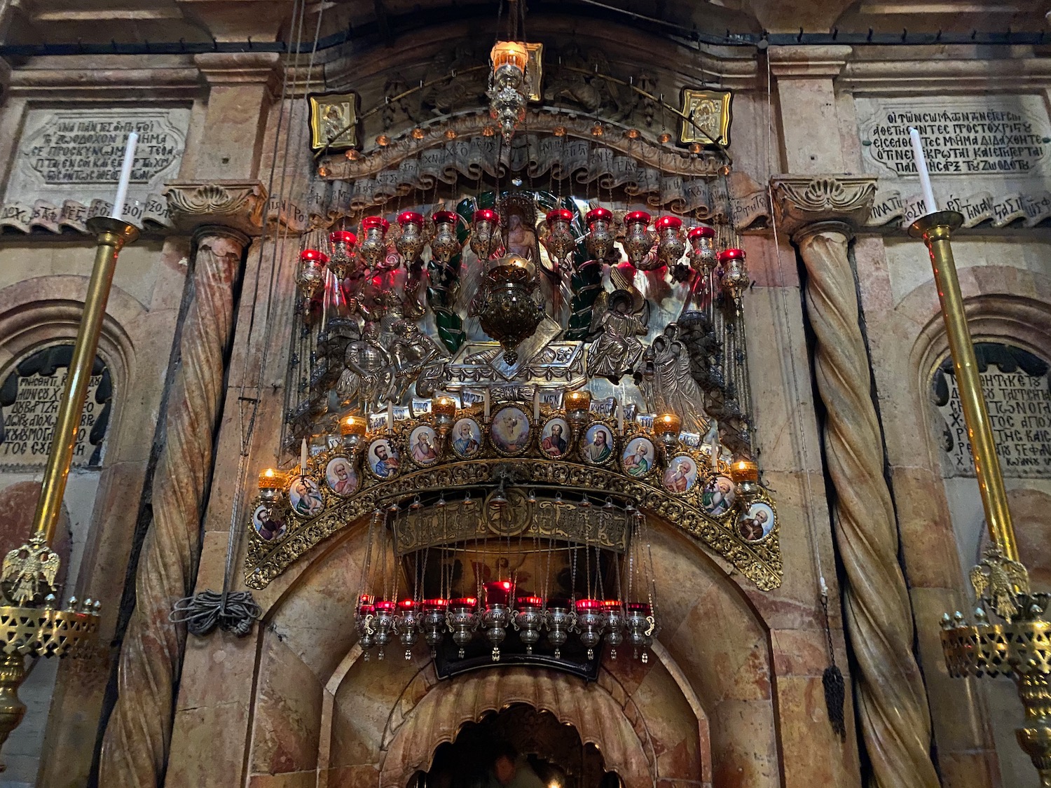 a ornate arch with ornaments and candles