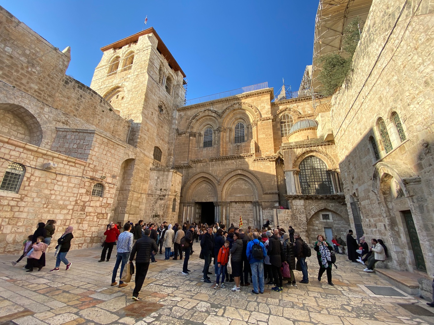 a group of people standing in a courtyard of Church of the Holy Sepulchre