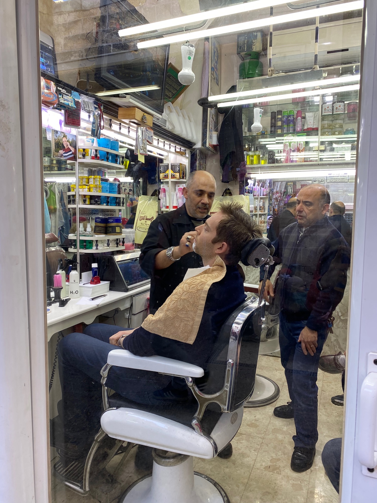 a man sitting in a chair in a barber shop