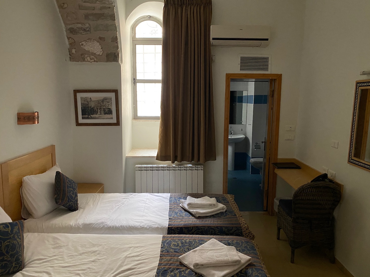 a room with two beds and a window