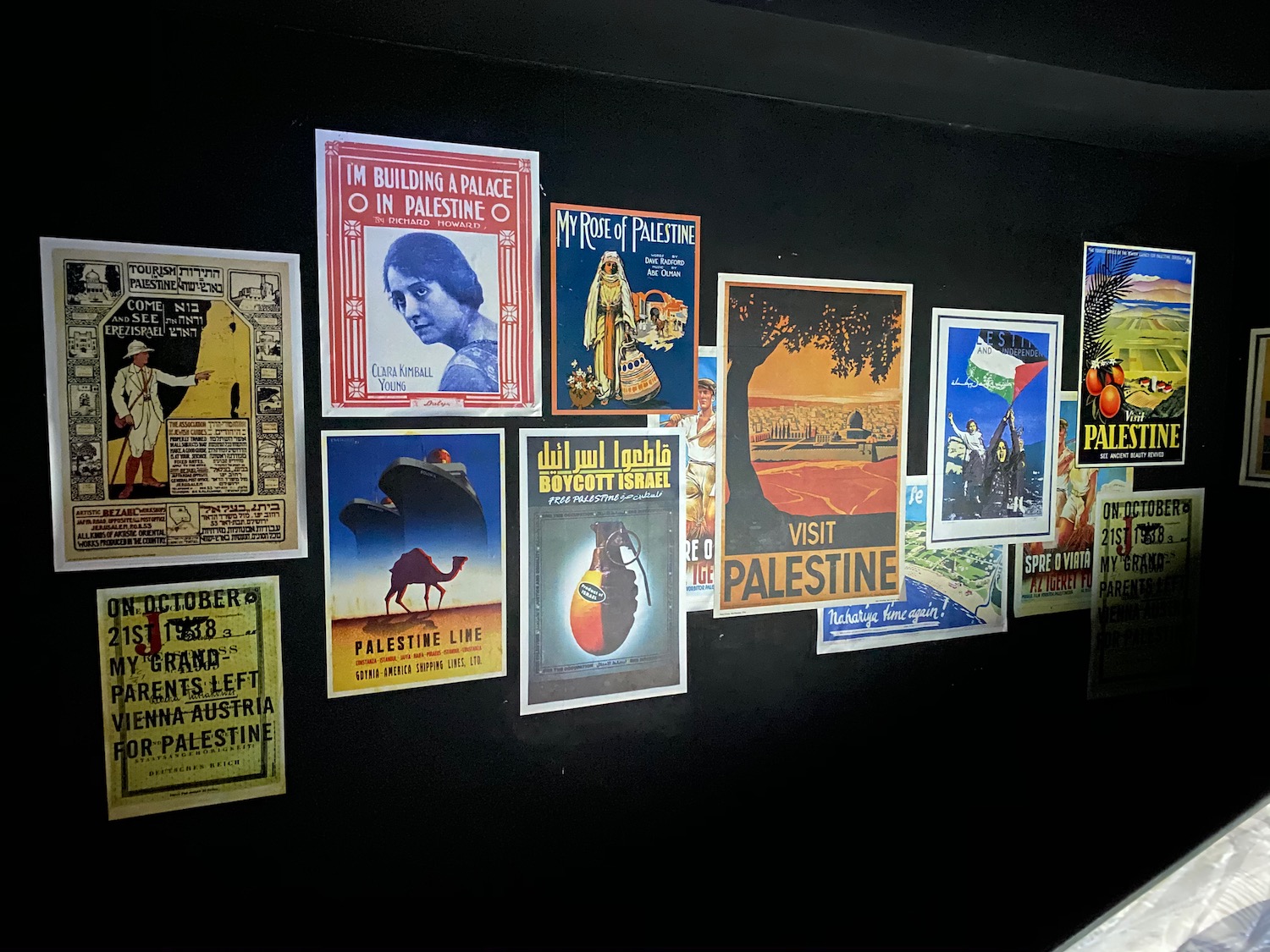 a group of posters on a black wall