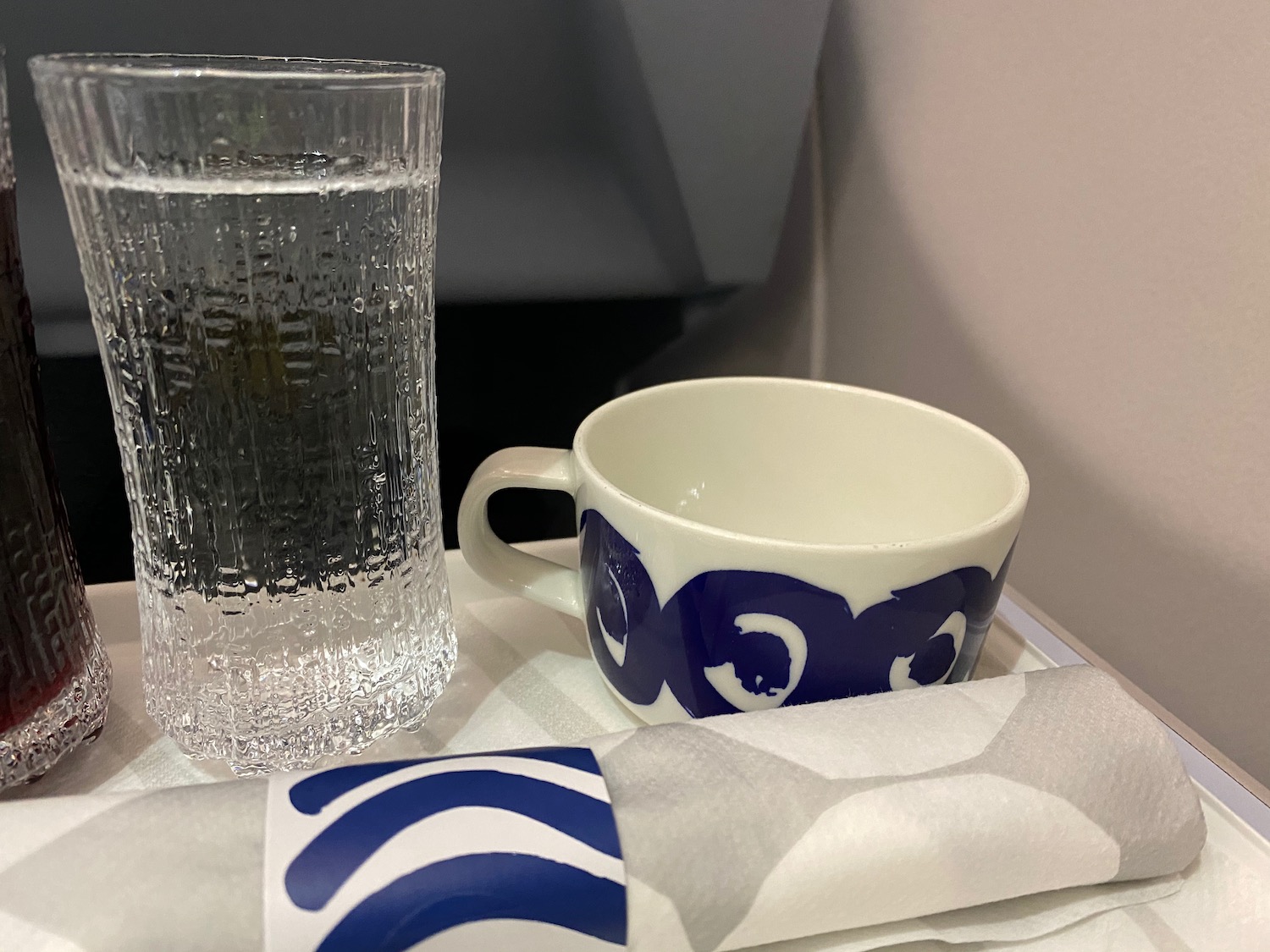a cup and a glass of water on a tray