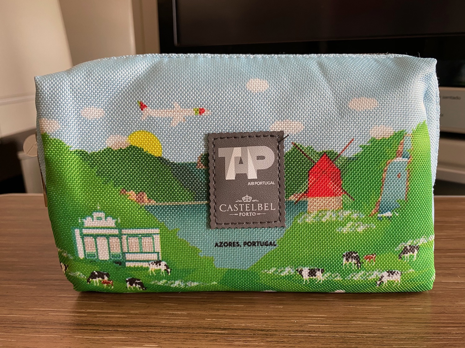 a small bag with a picture of a farm and a plane