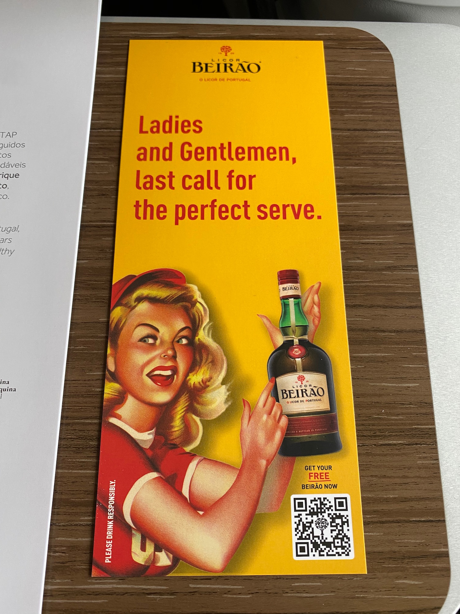 a yellow and red card with a woman and a bottle of liquor