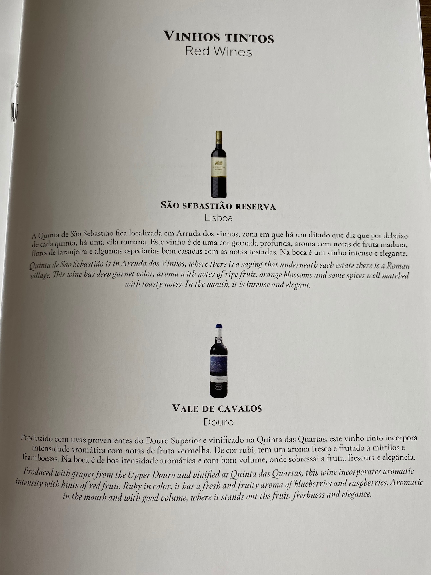 a book with text and bottles of wine