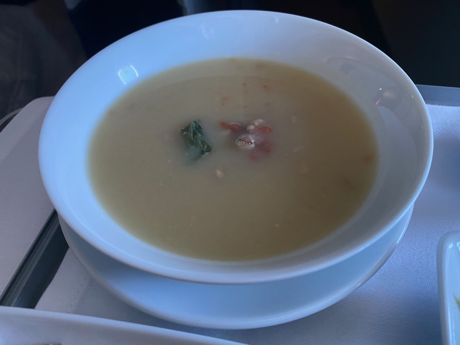 a bowl of soup on a white plate