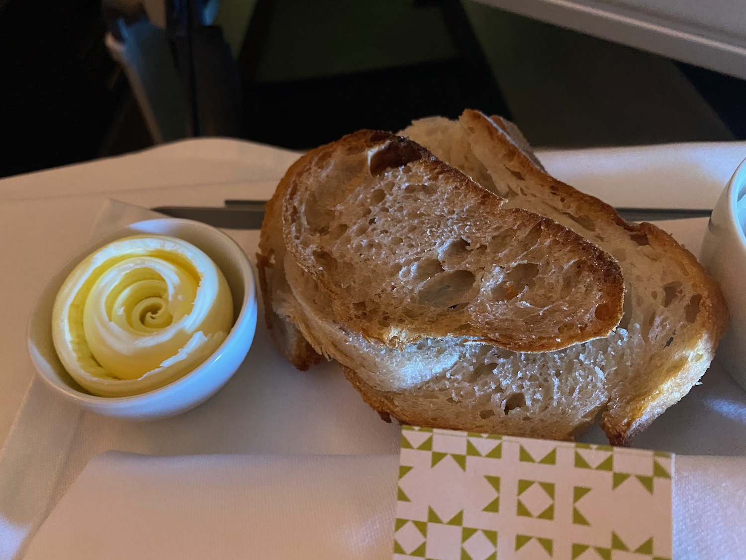 a piece of bread with butter on a white napkin