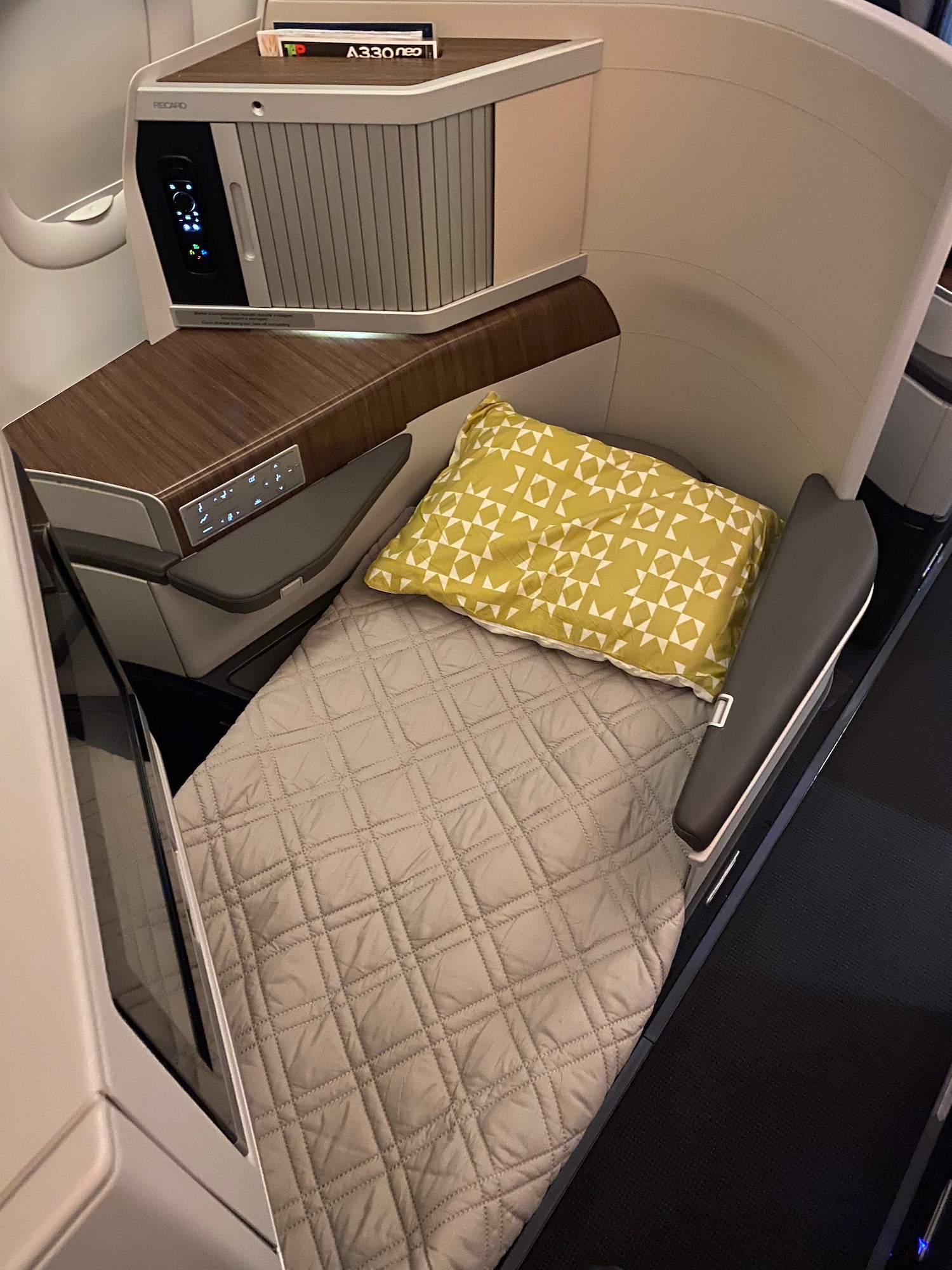 a bed and a pillow on a plane