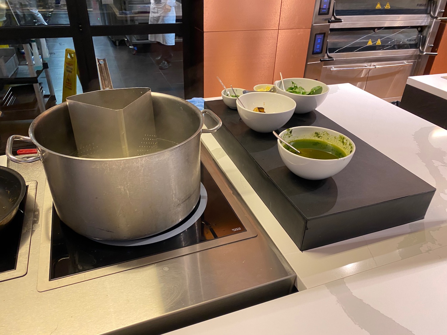 a pot and bowls of soup on a stove