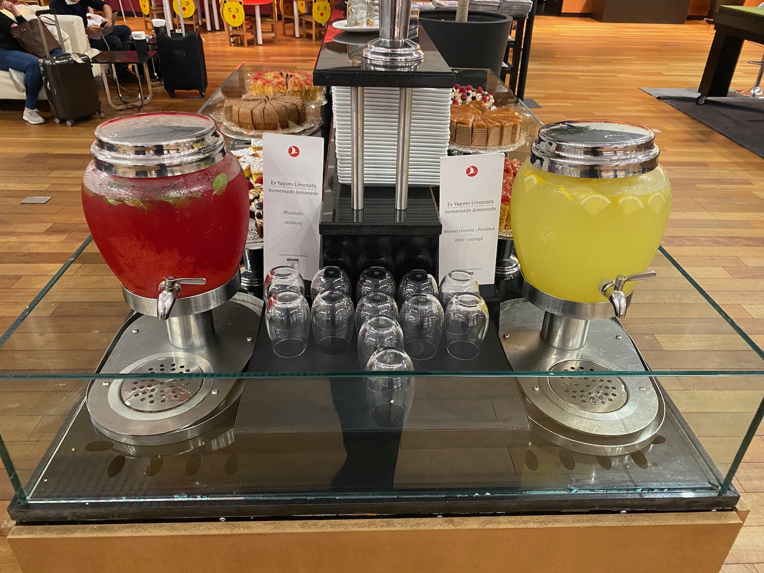 a beverage dispenser with a drink dispenser and glasses